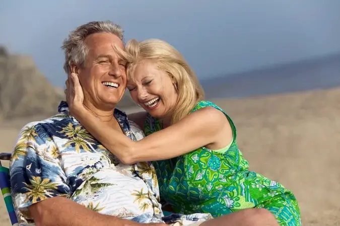 Smiling man and woman at the beach.